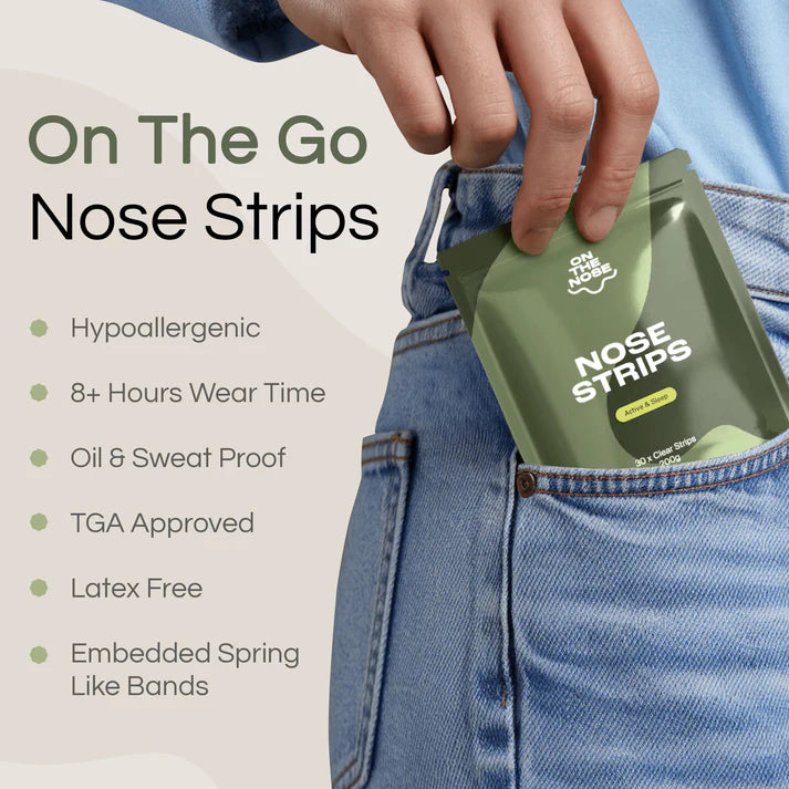 Person holding a package of 'On The Go' nose strips with product features listed.